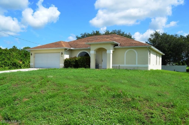 3808 27th St SW, Lehigh Acres, FL 33976 - view of front facade with stucco siding, a garage, a front lawn, and driveway