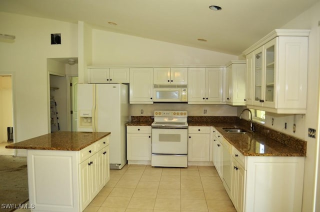 3808 27th St SW, Lehigh Acres, FL 33976 - kitchen featuring white appliances, lofted ceiling, a kitchen island, glass insert cabinets, and dark stone countertops