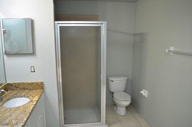 3808 27th St SW, Lehigh Acres, FL 33976 - full bathroom featuring vanity, a shower stall, and tile patterned floors