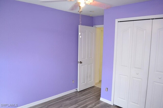 3808 27th St SW, Lehigh Acres, FL 33976 - unfurnished bedroom featuring wood finished floors, a closet, and ceiling fan