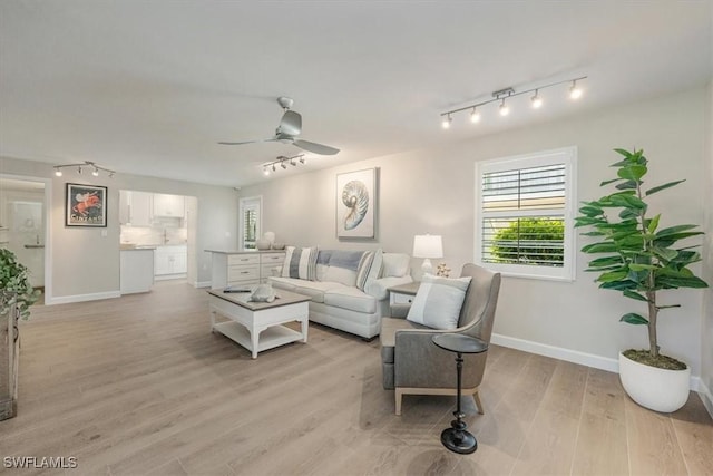 626 12th Ave S Unit 626, Naples, FL 34102 - living area with track lighting, ceiling fan, and light wood-style floors