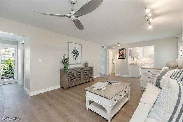626 12th Ave S Unit 626, Naples, FL 34102 - living area featuring track lighting, ceiling fan, and light wood-type flooring