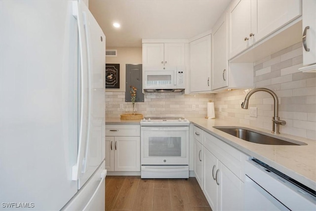 626 12th Ave S Unit 626, Naples, FL 34102 - kitchen with white appliances, white cabinets, tasteful backsplash, light wood-style flooring, and light stone countertops