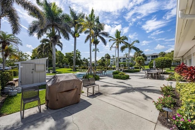 626 12th Ave S Unit 626, Naples, FL 34102 - view of patio with a grill and a storage shed