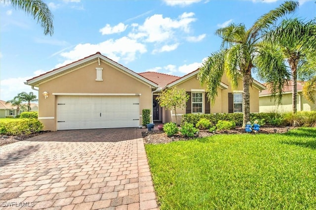 3200 Birch Tree Ln, Alva, FL 33920 - ranch-style house featuring stucco siding, decorative driveway, an attached garage, a front lawn, and a tiled roof