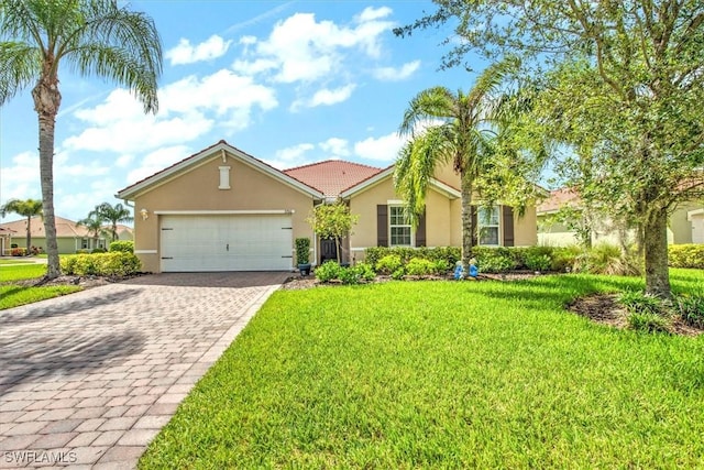 3200 Birch Tree Ln, Alva, FL 33920 - view of front of home with stucco siding, a garage, decorative driveway, and a front lawn