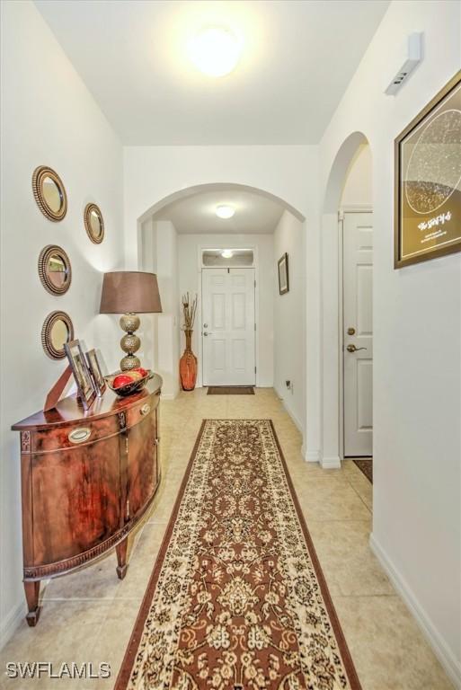 3200 Birch Tree Ln, Alva, FL 33920 - hall with arched walkways and light tile patterned flooring