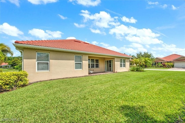3200 Birch Tree Ln, Alva, FL 33920 - back of house featuring a lawn, stucco siding, and a tile roof