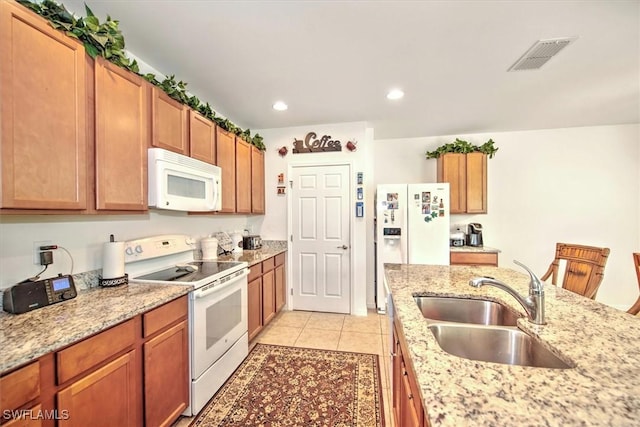 3200 Birch Tree Ln, Alva, FL 33920 - kitchen with white appliances, light tile patterned floors, recessed lighting, light stone counters, and brown cabinets