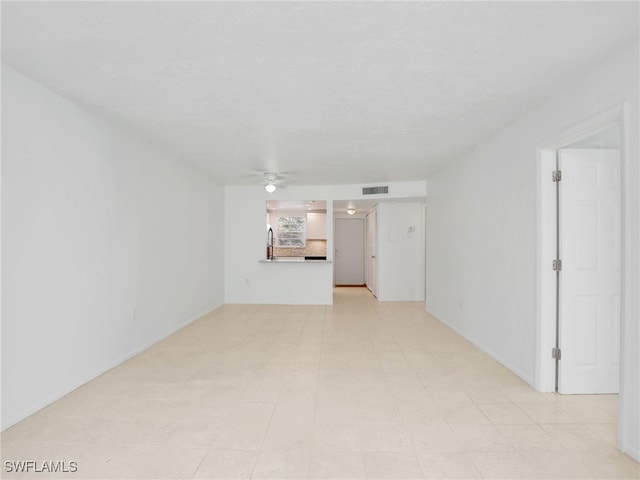 499 Forest Lakes Blvd Unit 207, Naples, FL 34105 - unfurnished living room featuring ceiling fan and baseboards