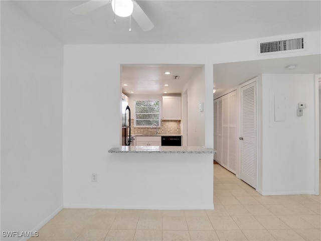 499 Forest Lakes Blvd Unit 207, Naples, FL 34105 - kitchen with backsplash, a ceiling fan, light stone counters, white cabinetry, and black dishwasher