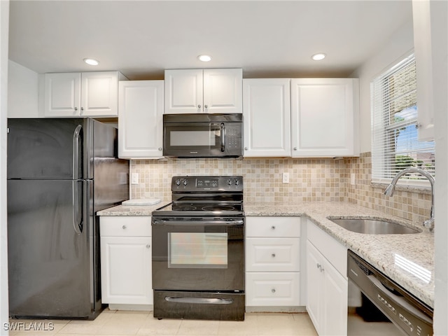 499 Forest Lakes Blvd Unit 207, Naples, FL 34105 - kitchen with black appliances, light stone counters, white cabinetry, decorative backsplash, and recessed lighting