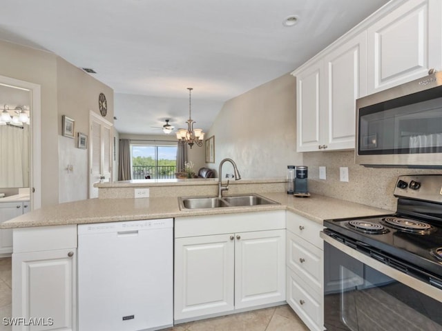 1315 Mainsail Dr Unit 1114, Naples, FL 34114 - kitchen with white dishwasher, electric range, stainless steel microwave, a peninsula, and a chandelier