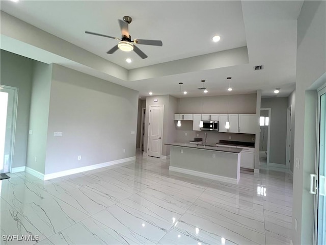 4208 28th St SW, Lehigh Acres, FL 33976 - kitchen featuring stainless steel microwave, open floor plan, a ceiling fan, white cabinetry, and recessed lighting