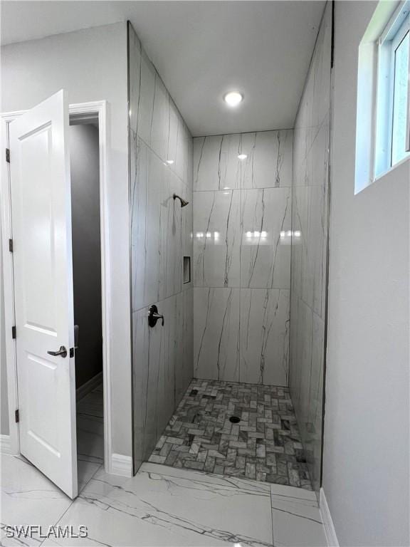 4208 28th St SW, Lehigh Acres, FL 33976 - bathroom featuring a tile shower and marble finish flooring