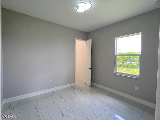 4208 28th St SW, Lehigh Acres, FL 33976 - spare room with light marble finish flooring and baseboards