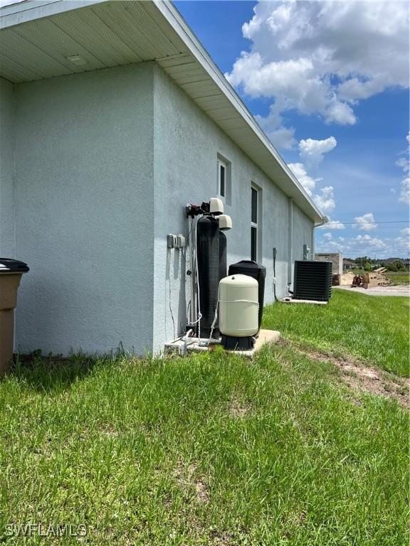 4208 28th St SW, Lehigh Acres, FL 33976 - view of home's exterior featuring stucco siding and a yard