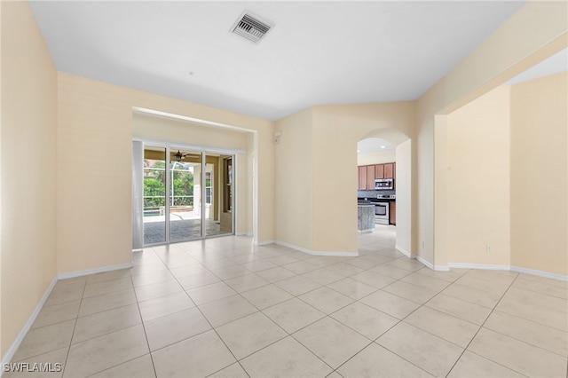 2628 Fairmont Cove Ct, Cape Coral, FL 33991 - empty room featuring light tile patterned floors and arched walkways
