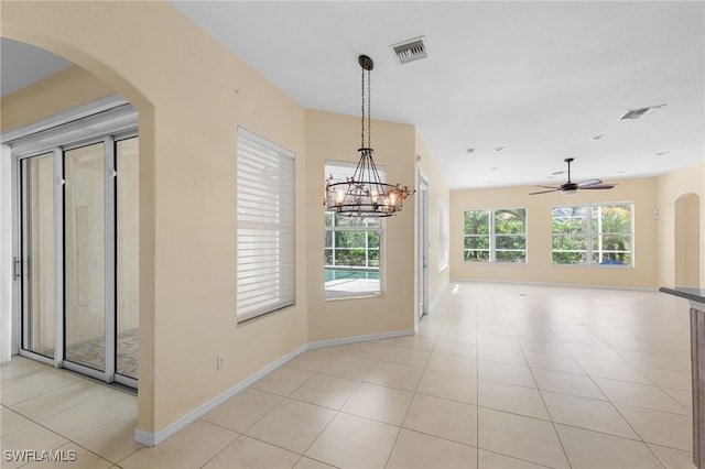 2628 Fairmont Cove Ct, Cape Coral, FL 33991 - unfurnished dining area with arched walkways, light tile patterned floors, a ceiling fan, and a chandelier