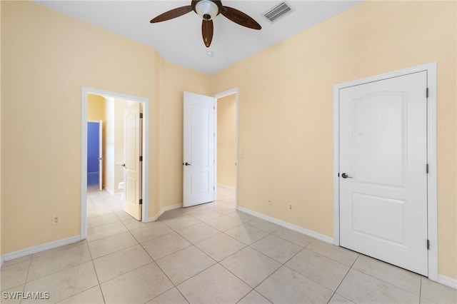 2628 Fairmont Cove Ct, Cape Coral, FL 33991 - unfurnished bedroom featuring light tile patterned flooring, ensuite bath, and a ceiling fan