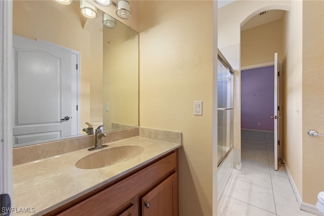 2628 Fairmont Cove Ct, Cape Coral, FL 33991 - full bathroom featuring tile patterned flooring, vanity, a textured wall, and bath / shower combo with glass door