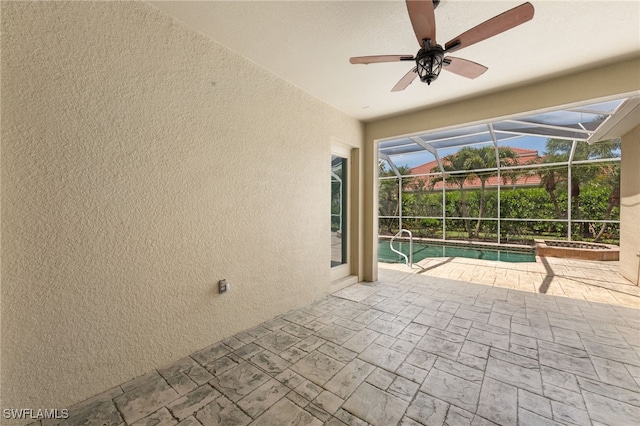 2628 Fairmont Cove Ct, Cape Coral, FL 33991 - view of patio with ceiling fan, glass enclosure, and a pool with connected hot tub