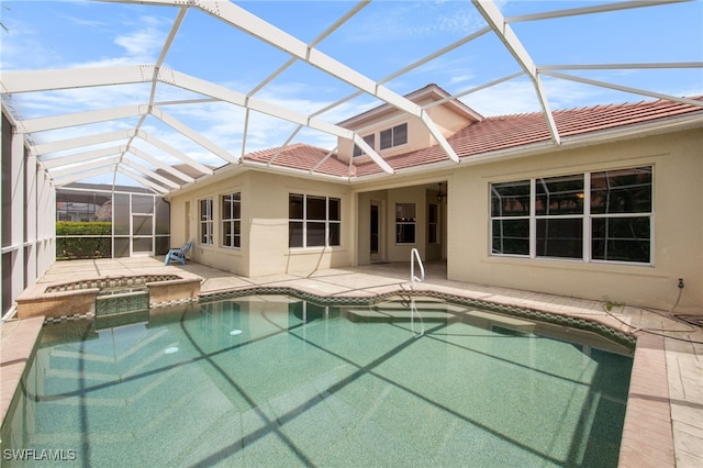 2628 Fairmont Cove Ct, Cape Coral, FL 33991 - view of swimming pool with a patio area, glass enclosure, and a pool with connected hot tub
