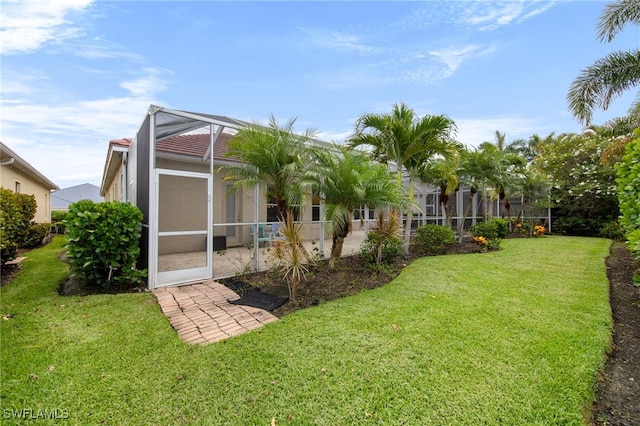 2628 Fairmont Cove Ct, Cape Coral, FL 33991 - back of house with a yard and glass enclosure