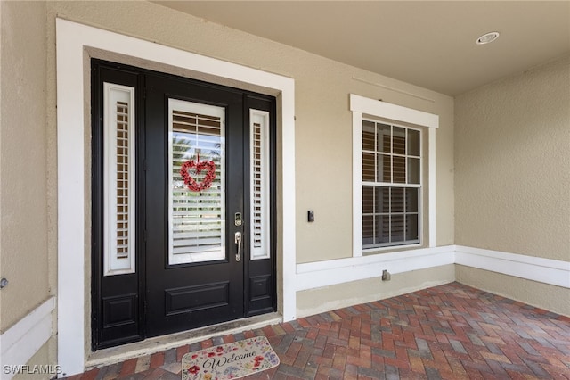 2628 Fairmont Cove Ct, Cape Coral, FL 33991 - view of exterior entry featuring stucco siding