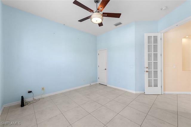 2628 Fairmont Cove Ct, Cape Coral, FL 33991 - empty room featuring a ceiling fan, french doors, light tile patterned flooring, a smoke detector, and arched walkways