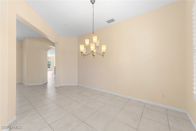 2628 Fairmont Cove Ct, Cape Coral, FL 33991 - spare room with arched walkways, light tile patterned floors, and a chandelier