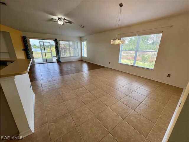 8000 Fountain Mist Blvd, Lehigh Acres, FL 33972 - unfurnished dining area with light tile patterned floors and a ceiling fan
