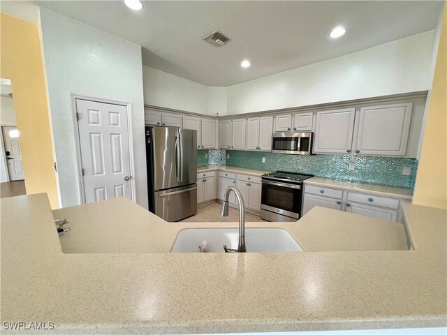 8000 Fountain Mist Blvd, Lehigh Acres, FL 33972 - kitchen featuring appliances with stainless steel finishes, backsplash, light countertops, and recessed lighting