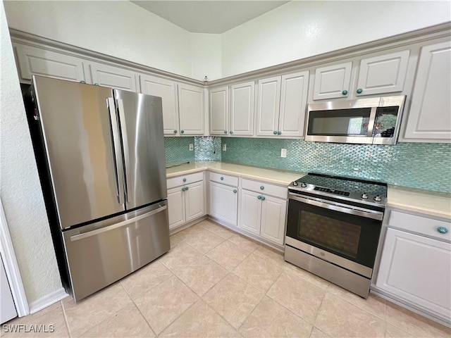 8000 Fountain Mist Blvd, Lehigh Acres, FL 33972 - kitchen featuring appliances with stainless steel finishes, light countertops, backsplash, and light tile patterned floors
