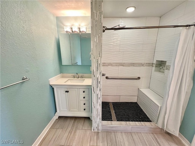 8000 Fountain Mist Blvd, Lehigh Acres, FL 33972 - bathroom with vanity, a stall shower, a textured wall, and wood tiled floors