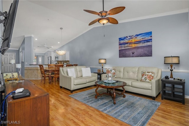2770 Cypress Trace Cir Unit 2428, Naples, FL 34119 - living area with a ceiling fan, wood finished floors, vaulted ceiling, and crown molding