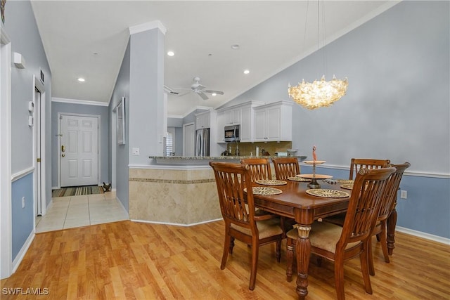 2770 Cypress Trace Cir Unit 2428, Naples, FL 34119 - dining area with light wood-style flooring, ceiling fan, a chandelier, crown molding, and vaulted ceiling