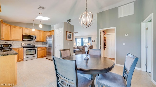 301 SE 26th Ter, Cape Coral, FL 33904 - dining space featuring a chandelier, a skylight, light tile patterned floors, and lofted ceiling