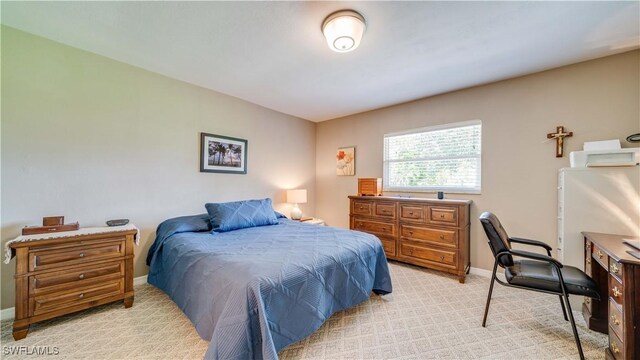 301 SE 26th Ter, Cape Coral, FL 33904 - bedroom featuring light carpet and baseboards