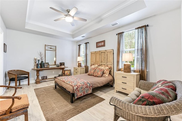 28082 Sosta Ln Unit 2, Bonita Springs, FL 34135 - bedroom featuring a raised ceiling, multiple windows, light wood finished floors, crown molding, and ceiling fan