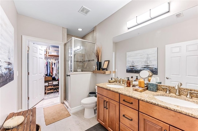 28082 Sosta Ln Unit 2, Bonita Springs, FL 34135 - bathroom featuring a shower stall, double vanity, tile patterned flooring, and a walk in closet
