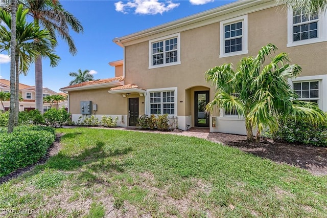 28082 Sosta Ln Unit 2, Bonita Springs, FL 34135 - view of front of home featuring stucco siding, a front yard, and a tile roof