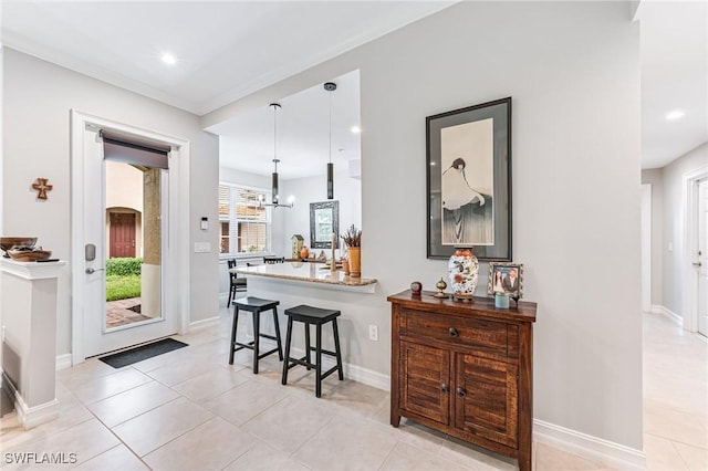 28082 Sosta Ln Unit 2, Bonita Springs, FL 34135 - bar area featuring recessed lighting, light tile patterned floors, a chandelier, and hanging light fixtures