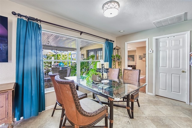 4512 SW 20th Ave, Cape Coral, FL 33914 - dining space featuring baseboards and a textured ceiling