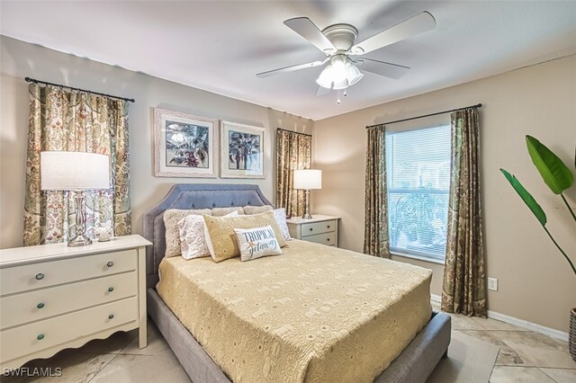 4512 SW 20th Ave, Cape Coral, FL 33914 - bedroom with light tile patterned flooring and a ceiling fan