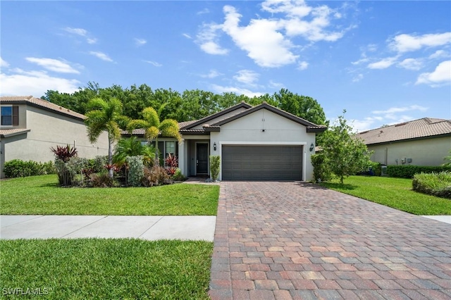 3336 Hampton Blvd, Alva, FL 33920 - ranch-style home with an attached garage, decorative driveway, a front lawn, and stucco siding