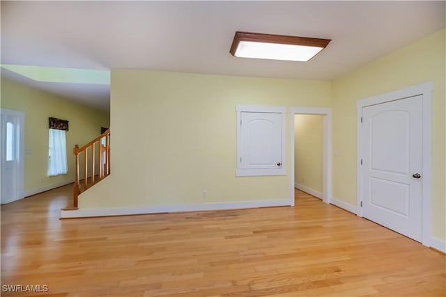 202 N Cypress St, Labelle, FL 33935 - empty room with light wood-style floors and stairway