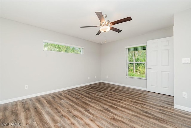 849 Haleybury St, Port Charlotte, FL 33948 - spare room with healthy amount of natural light, wood finished floors, and a ceiling fan