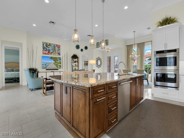 23220 Whispering Ridge Dr, Estero, FL 34135 - kitchen featuring appliances with stainless steel finishes, a chandelier, white cabinets, recessed lighting, and light stone counters