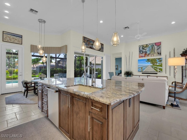 23220 Whispering Ridge Dr, Estero, FL 34135 - kitchen with recessed lighting, light stone countertops, ceiling fan, dishwasher, and plenty of natural light